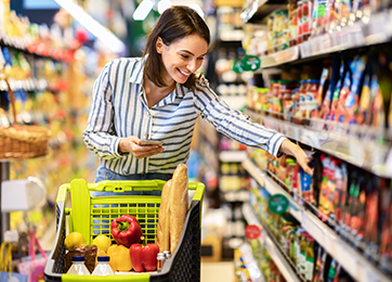 Shopping.,Young,Smiling,Woman,Holding,And,Using,Mobile,Phone,Buying
